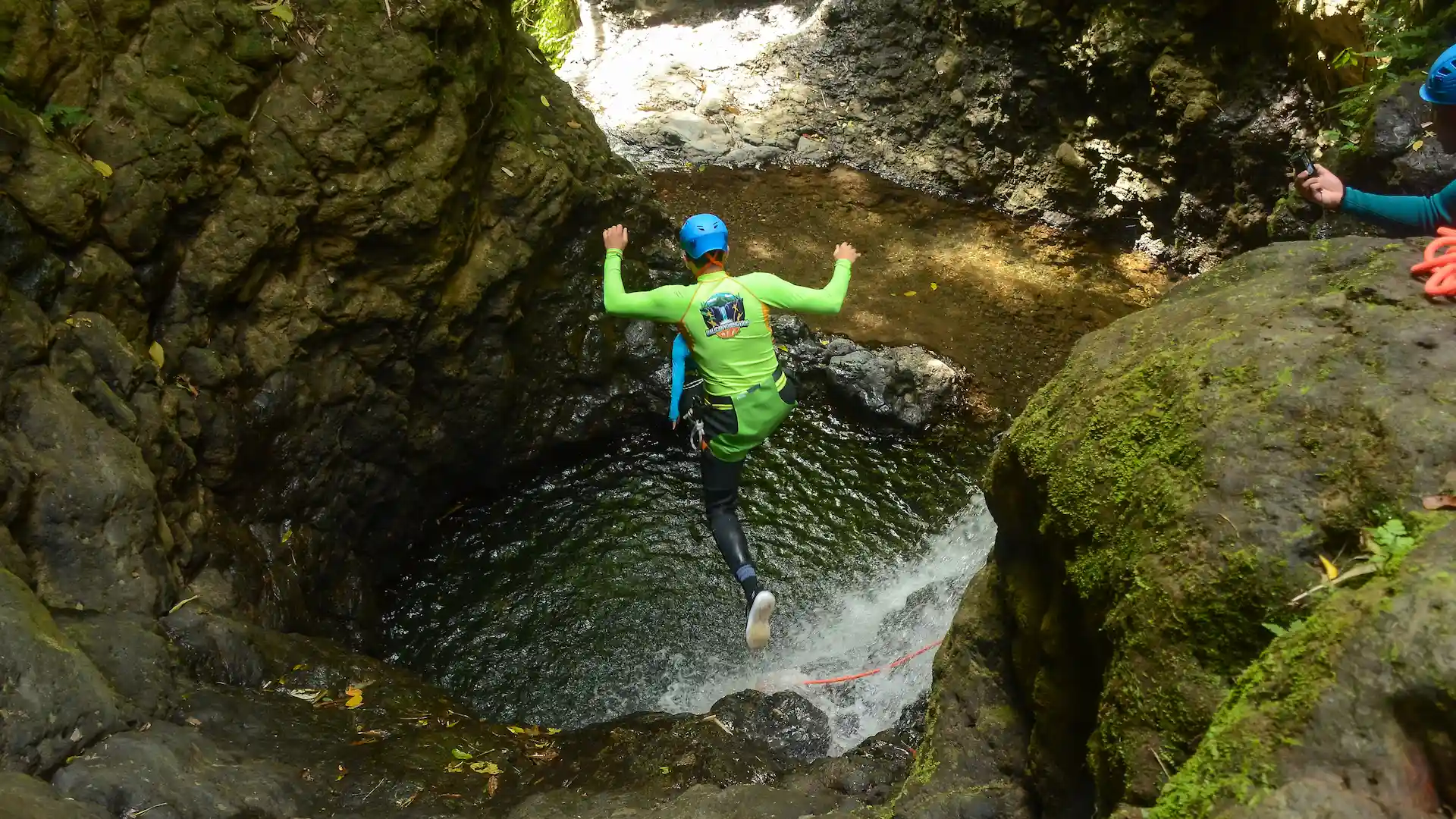 Cliff jump into a canyon pool