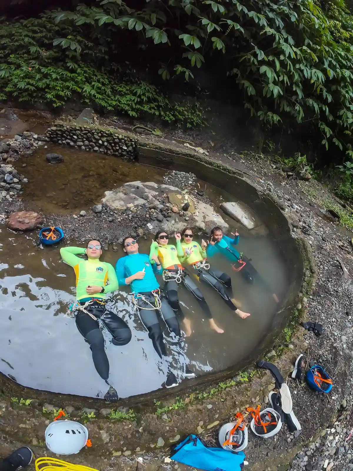 Guests relaxing in a natural hot spring after the canyon