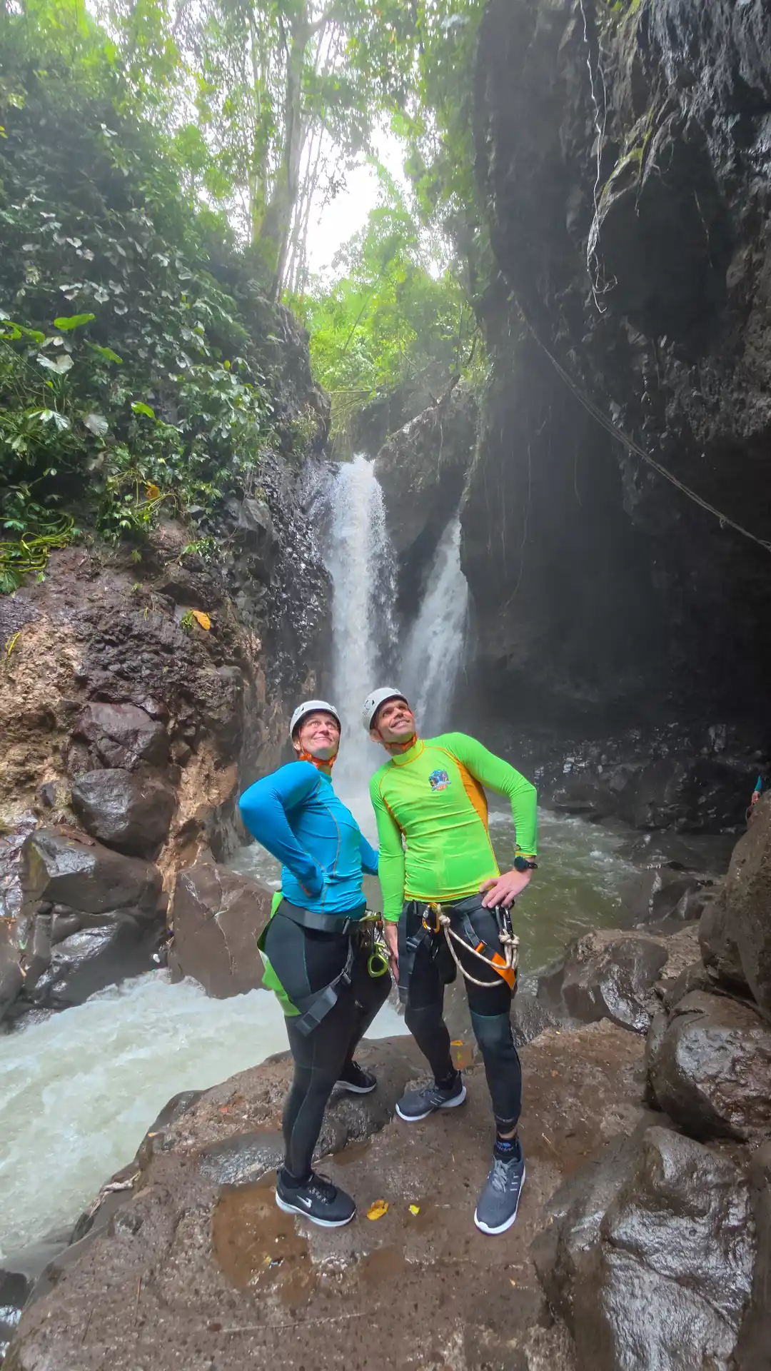 Guest standing between the twin waterfalls in the canyon