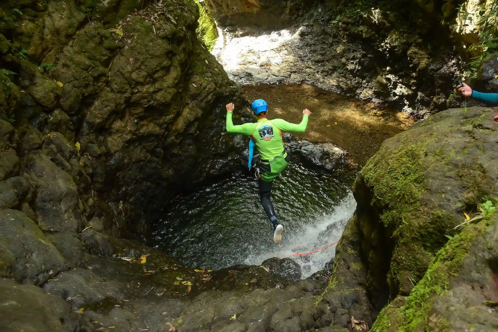 Jumping into a calm canyon pool