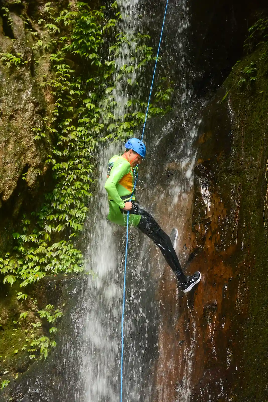 Descending a jungle waterfall on rope