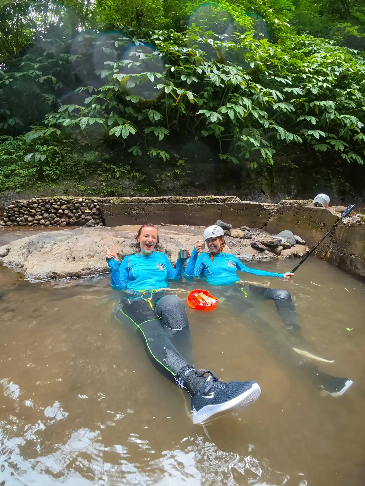 Guests relaxing in a natural hot spring after the canyon