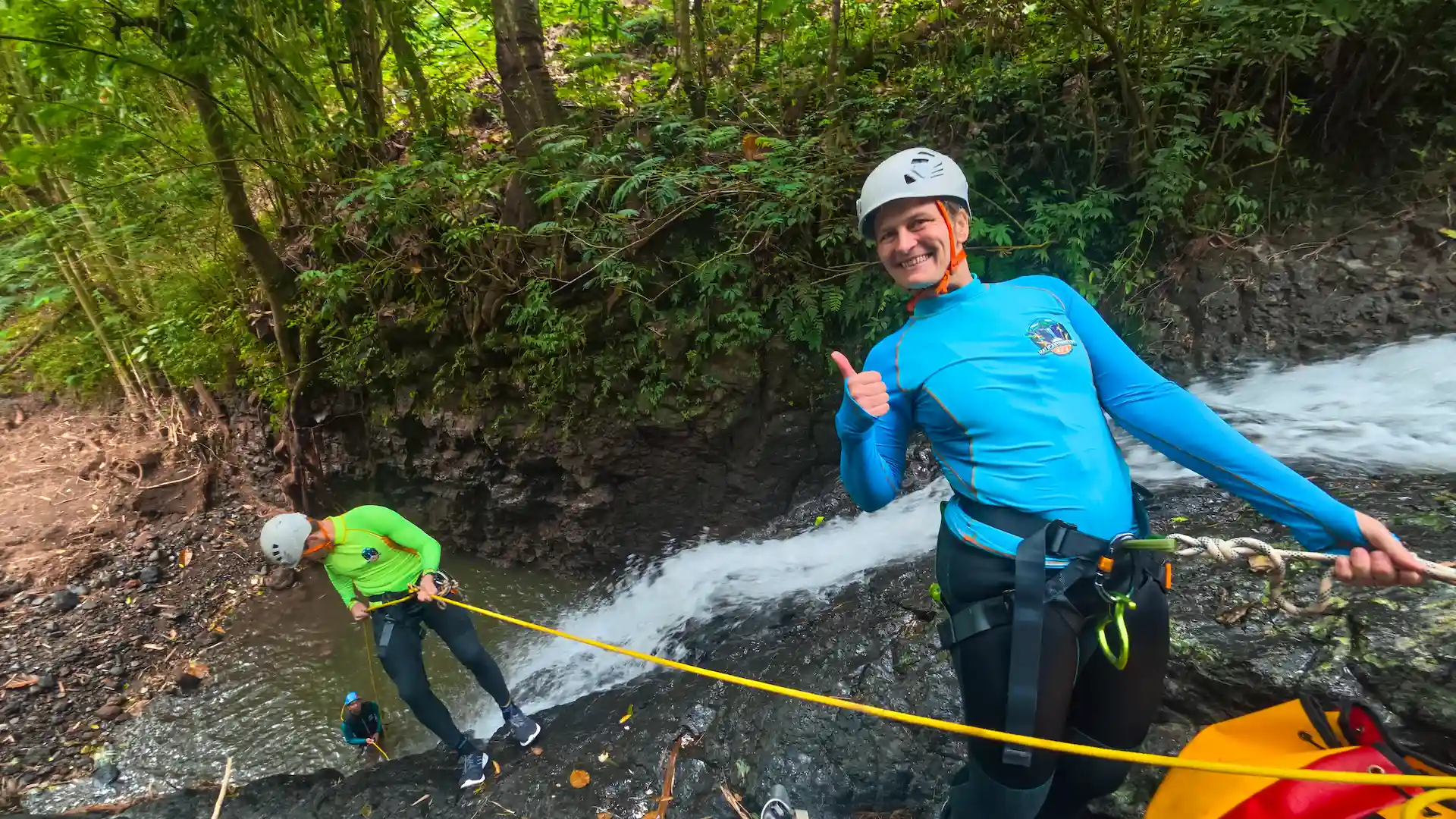 Rappelling through a waterfall on a canyoning trip in North Bali