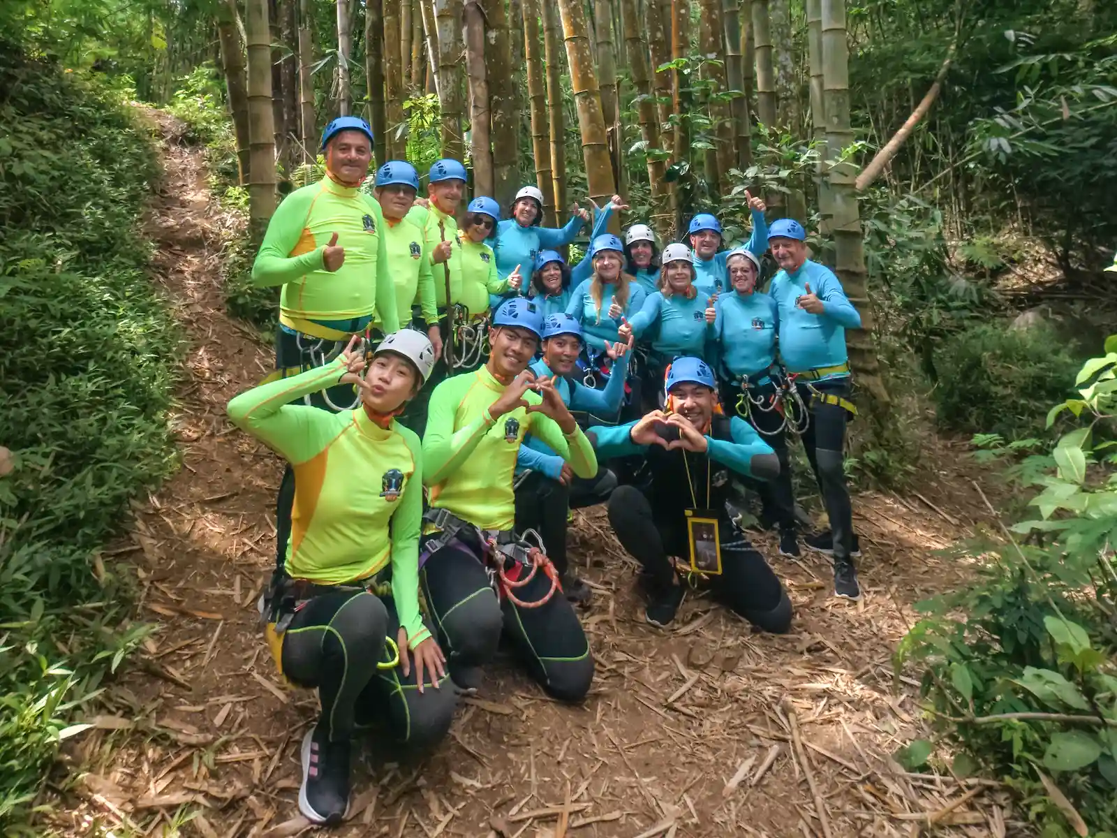 Local canyoning guides with a group in helmets and harnesses in North Bali